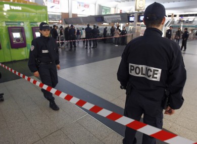 Police officers stand near the spot where the soldier was stabbed