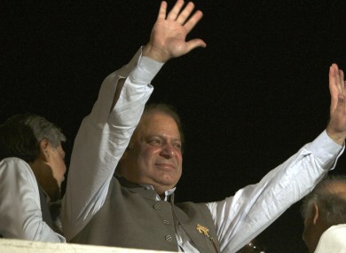 Nawaz Sharif waves to his supporters at a party office in Lahore last night