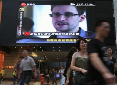 A TV screen in Hong Kong shows a news report on Edward Snowden