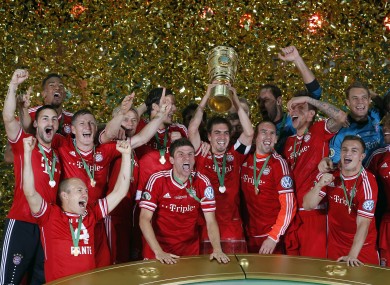 Bayern's players celebrate with the trophy during the winning ceremony for the German Soccer Cup Final.