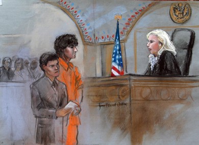 This courtroom sketch depicts Boston Marathon bombing suspect Dzhokhar Tsarnaev standing with his lawyer Miriam Conrad.