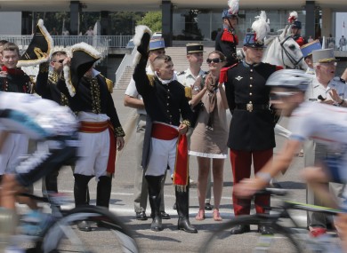 Cadets of the Special Military School of Saint-Cyr salute the peloton as it passes.