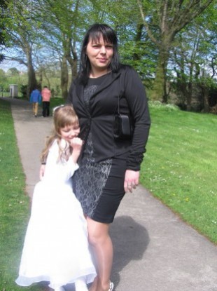 Jolanta Lubiene with her eight-year-old daughter Enrika at her Holy Communion in May.