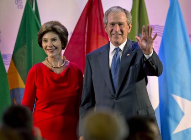 George W Bush on stage with his wife at the