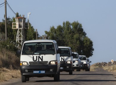 UN vehicles drive into a UN base near the Quneitra crossing between the Israeli-controlled Golan Heights and Syria.