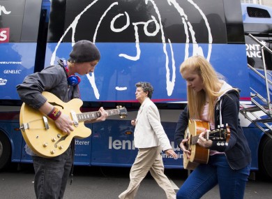 Two young guitarists play outside the John Lennon Educational Bus.