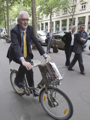 Brian Cookson poses for photographs after a press conference in Paris.