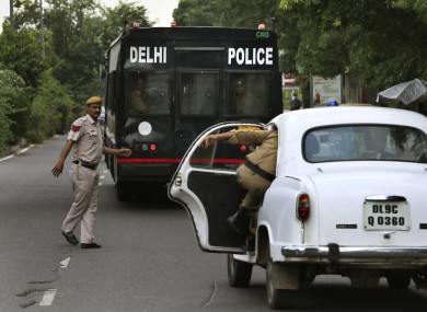 A police car escorts the van carrying four men convicted in the fatal gang rape of a young woman on a moving New Delhi bus.