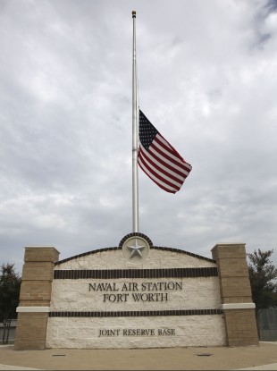 The flag flies at half-staff at the front entrance of the Naval Air Station Joint Reserve Base in Fort Worth, Texas.