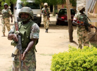 Nigerian soldiers stand guard at the offices of the state-run TV station. (Dated 6 June)