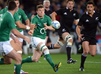 Brian O'Driscoll spins a pass under the watchful gaze of Richie McCaw and Dan Carter.
