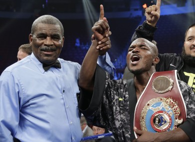 Timothy Bradley shouts to fans as he poses for photos with the title belt and referee Robert Byrd.
