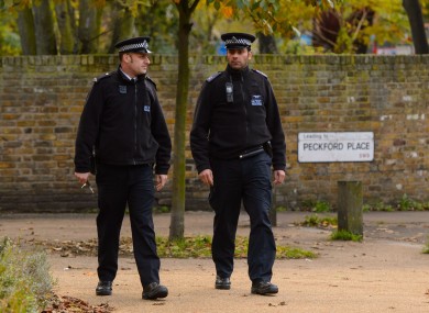 Police officers patrol near flats in Brixton, south London, as police are conducting house-to-house inquires in the area where three women were allegedly held as slaves for at least 30 years were rescued.