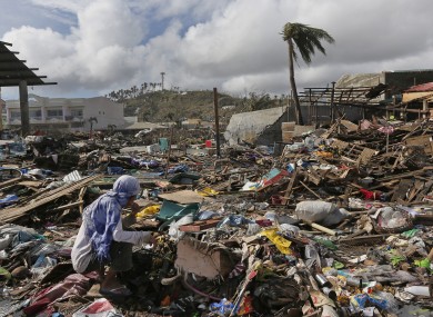 A survivor eats a banana found in a garbage heap.