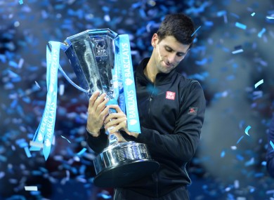 Djokovic lifts the trophy.