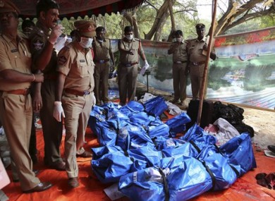 Police officers stand by the bodies of passengers killed in a train accident at Kothacheruvu, about 155 kilometers north of Bangalore, India.