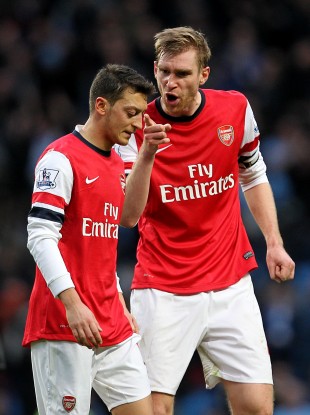 Arsenal's Per Mertesacker (right) shouts at team-mate Mesut Ozil after the final whistle.