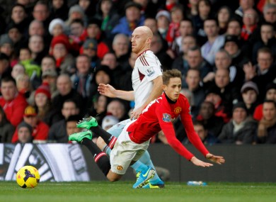 Manchester United's Adnan Januzaj (right) before being booked for diving after taking a tumble ahead of West Ham United's James Collins.