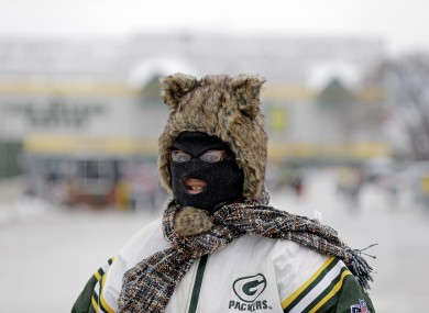 A Green Bay Packers fan is seen bundled up before the NFL wild-card playoff football game between the Green Bay Packers and the San Francisco 49ers