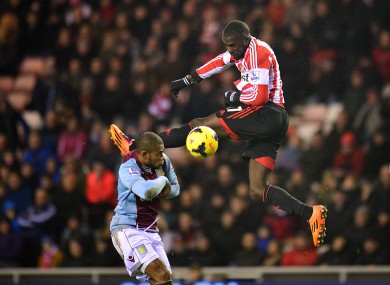 Sunderland's Jozy Altidore leaps to strike the ball alongside Aston Villa's Leandro Bacuna.