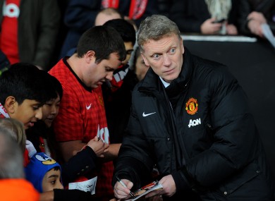 Manchester United manager David Moyes signs autographs for fans before the Capital One Cup defeat to Sunderland.