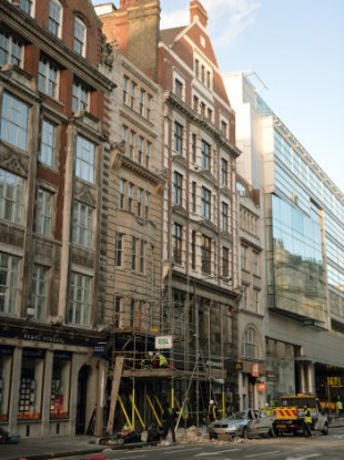 Workmen clear debris at the scene in Kingsway, opposite Holborn Tube station in central London, after a woman, named by police as Julie Sillitoe, 49, was killed when large chunks of masonry fell from the building above the Hiba restaurant on to her car.