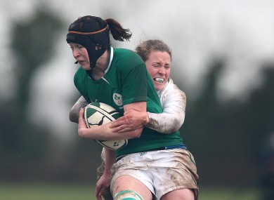 Marie Louise Reilly is tackled by England's Amber Reed.