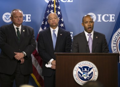 US Attorney Kenneth Allen Polite Jr., right, accompanied by US Customs and Border Protection Deputy Commissioner Thomas S. Winkowski, left, and Homeland Security Secretary Jeh Johnson speaks during a news conference at the US Immigration and Customs Enforcement (ICE) headquarters in Washington, where they discussed the results of a international operation involving an underground child pornography website.