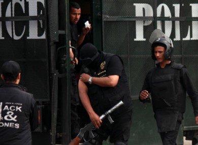 Riot police are seen getting ready at a police van outside a Cairo university.