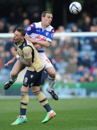 Queens Park Rangers' Richard Dunne and Leeds United's Connor Wickham.