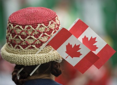 A woman wears miniature Canadian flags as she celebrates Canada Day.