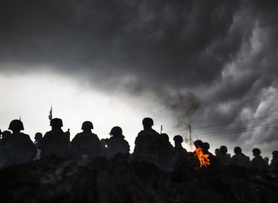 Ukrainian Army soldiers line up in front of Pro Russia civilians who where blocking the road in the Andreevka on Friday.