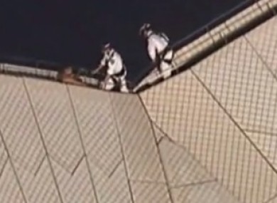 Authorities attempt to coax the man from the roof of Sydney Opera House in Australia.