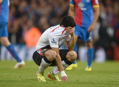 Luis Suarez covers his face at the end of Liverpool's 3-3 draw with Crystal Palace.