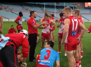 Tommy Walsh (front right) listens to Nick Davis addressing the Sydney Swans players.