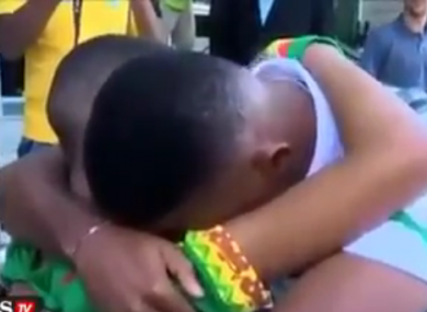 Samuel Eto'o hugs a distraught Cameroon fan.
