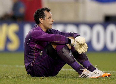 Ireland goalkeeper David Forde dejected after Portugal score.