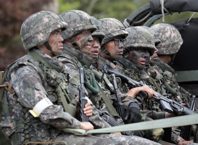 South Korean soldiers on a truck searching for the soldier who was on the run after the shooting