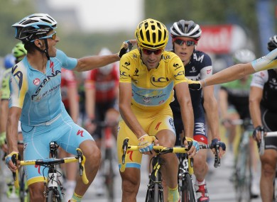 Italy's Vincenzo Nibali, centre, is congratulated by teammates as he crosses the finish line.