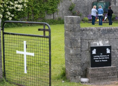 Members of the public pay their respects at the grounds where the unmarked mass grave containing the remains of nearly 800 infants.