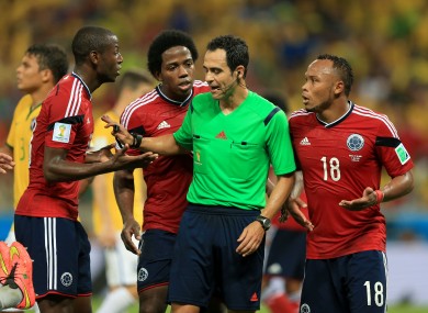 Colombia's Fredy Guarin (left) and Juan Camilo Zuniga (right) argue with the referee during the quarter final World Cup match against Brazil.