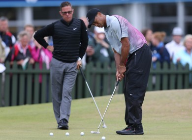 Woods practices putting with Foley watching on (file photo).