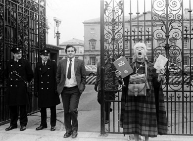 Bertie Ahern, then Chief Whip of Fianna Fáil outside Leinster House, as former school teacher Margaret dances in honour of the Holy Trinity and Virgin Mary.
