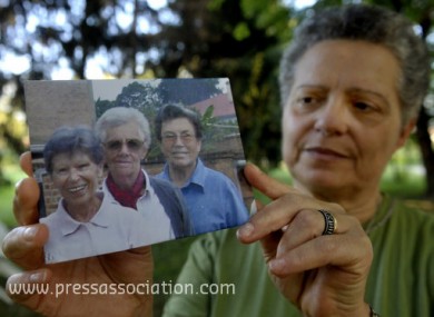 Silvia Marsili shows a photo of the three Italian missionary nuns, from left, Bernardetta Boggian, Olga Raschietti and Lucia Pulici