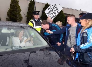 Joan Burton is pursued by water protesters at an event in Coolock earlier this month.