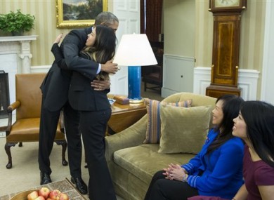 President Barack Obama hugs Ebola survivor Nina Pham in the Oval Office of the White House in Washington.