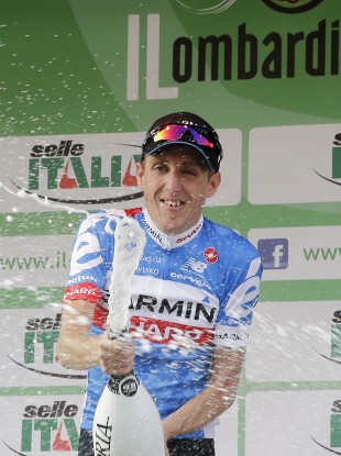 Ireland's Daniel Martin celebrates on the podium after winning the Tour of Lombardy cycling race.