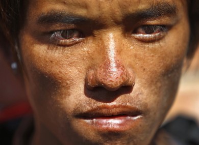 Sete Tamang, 20, avalanche survivor, waits to receive the bodies of his colleagues outside a morgue at Teaching Hospital in Katmandu, Nepal.