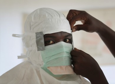 A MSF (Medecins Sans Frontieres) nurse gets prepared with Personal Protection Equipment in Liberia.