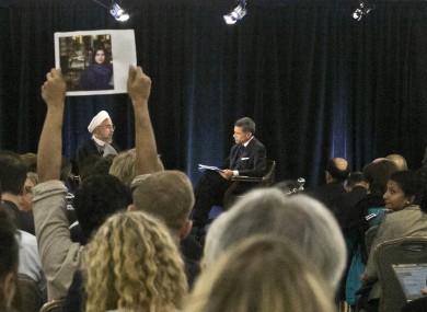 Protester holds up a picture of Ghoncheh Ghavami as Iran's President speaks in New York